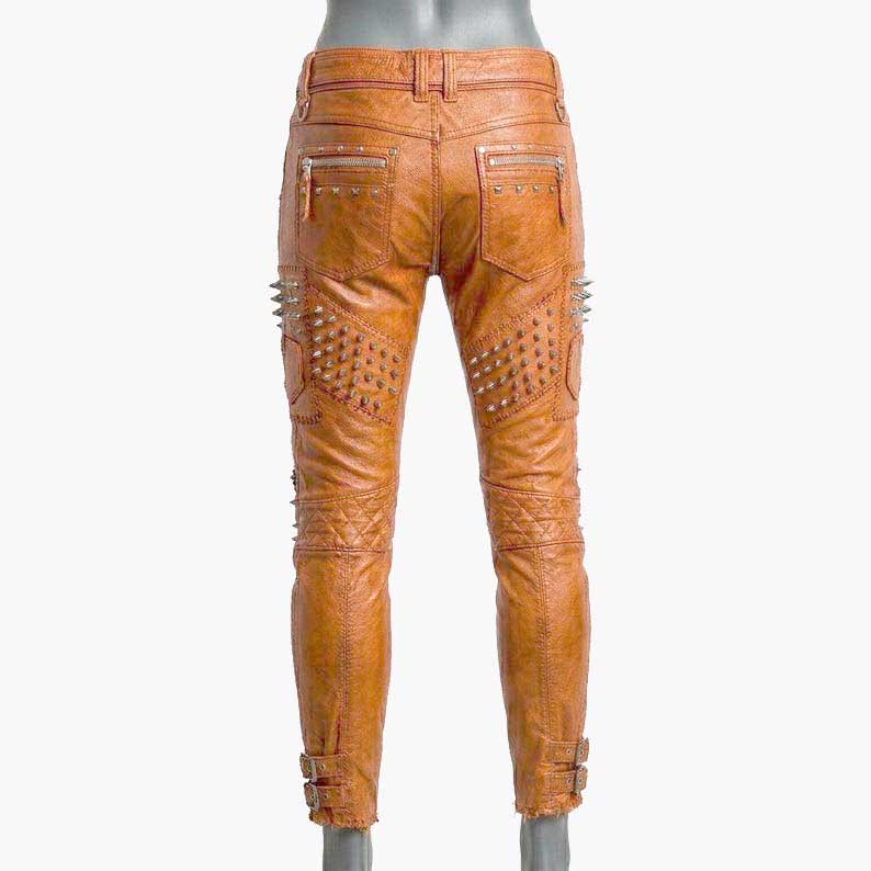 Stylish orange studded leather biker pants for sale featuring zipper accents and punk rock design