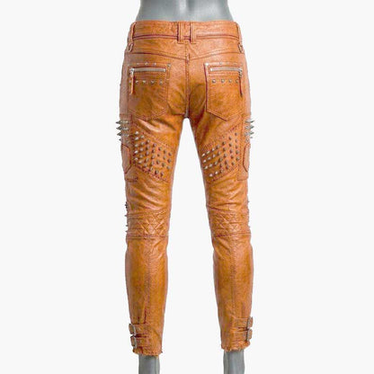 Stylish orange studded leather biker pants for sale featuring zipper accents and punk rock design